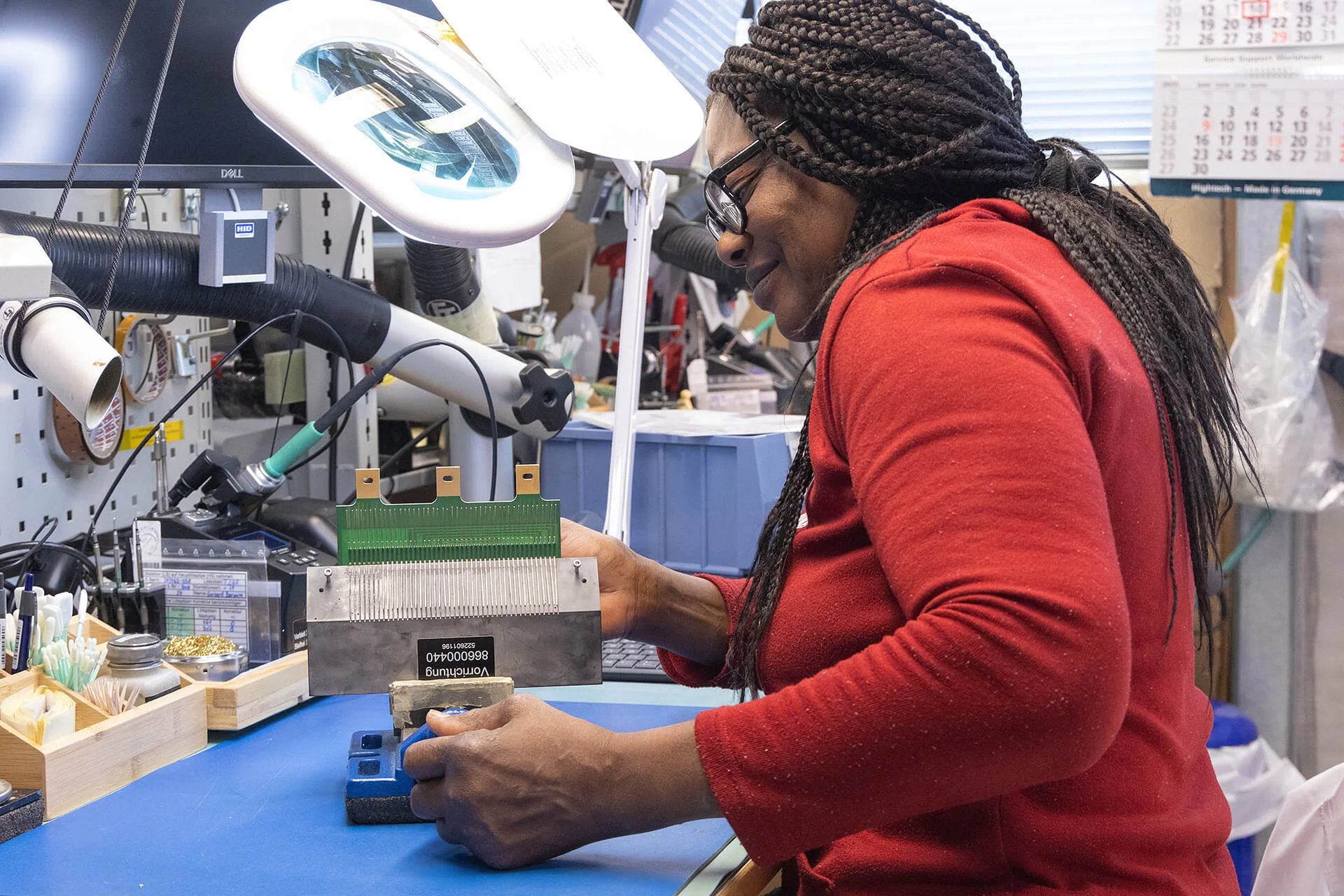 Electro-Miniatures employee assembling an electronic slip ring component